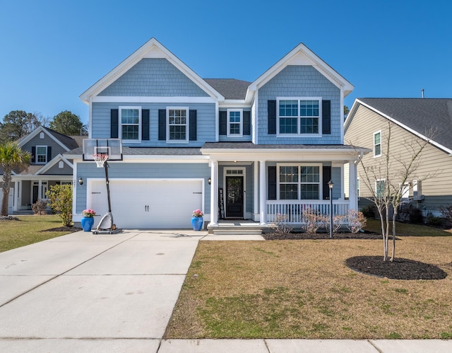 view of front of house with covered porch, a front lawn, concrete driveway, and a garage