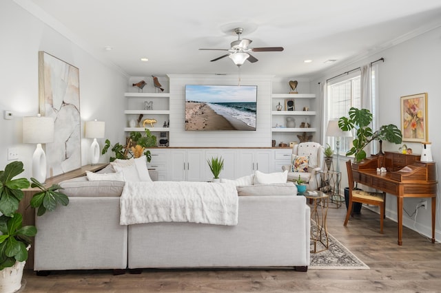 living area with built in features, recessed lighting, ceiling fan, ornamental molding, and light wood-style floors