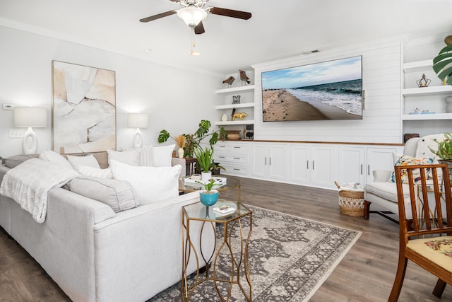 living room featuring ceiling fan, wood finished floors, visible vents, and ornamental molding