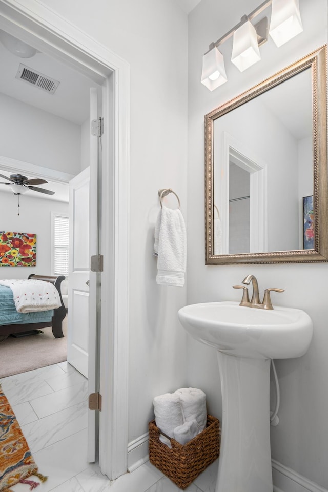 bathroom featuring a ceiling fan, visible vents, marble finish floor, and baseboards