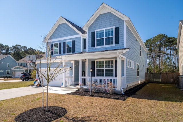 view of front of house with a front yard, fence, covered porch, and driveway