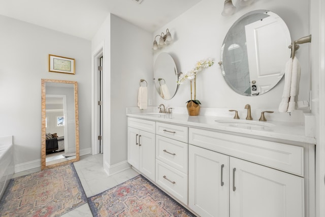 bathroom with a sink, baseboards, and marble finish floor