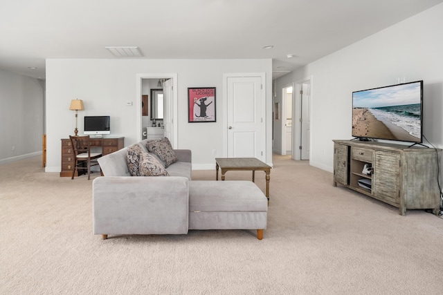 living room featuring visible vents, light carpet, and baseboards