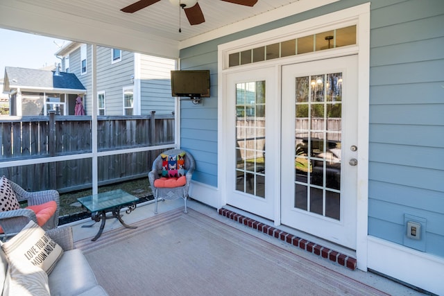 view of patio featuring french doors, a ceiling fan, and fence