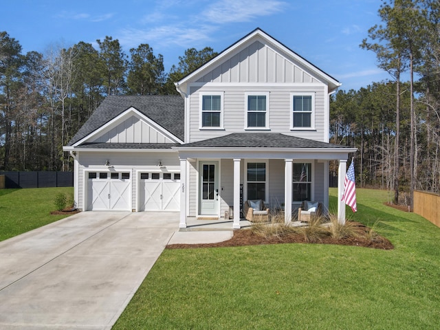 view of front of house with a garage, covered porch, and a front lawn