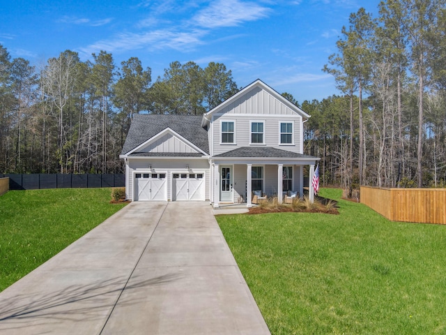 view of front of house with a garage, a front lawn, and a porch