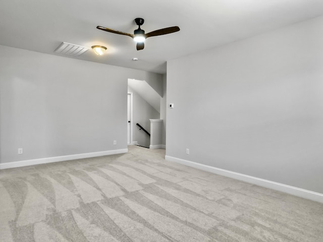 carpeted spare room with ceiling fan