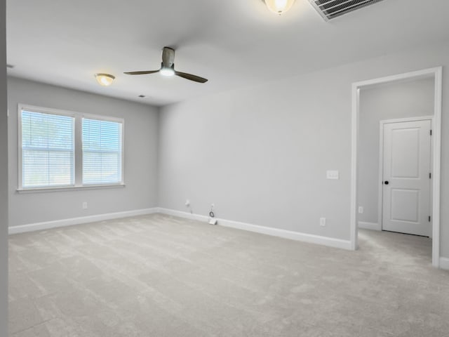 unfurnished room with ceiling fan and light carpet