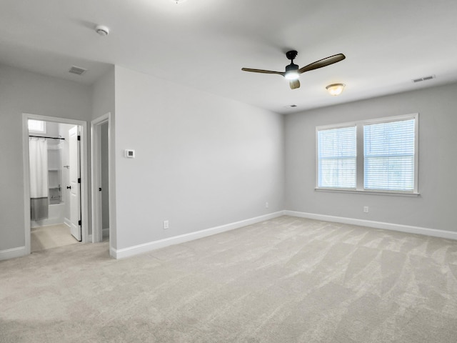 unfurnished room featuring light carpet and ceiling fan