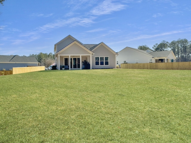 back of house with a yard