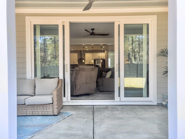 entrance to property with a patio and ceiling fan