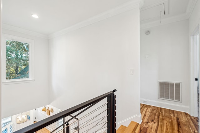 hall featuring crown molding and hardwood / wood-style flooring