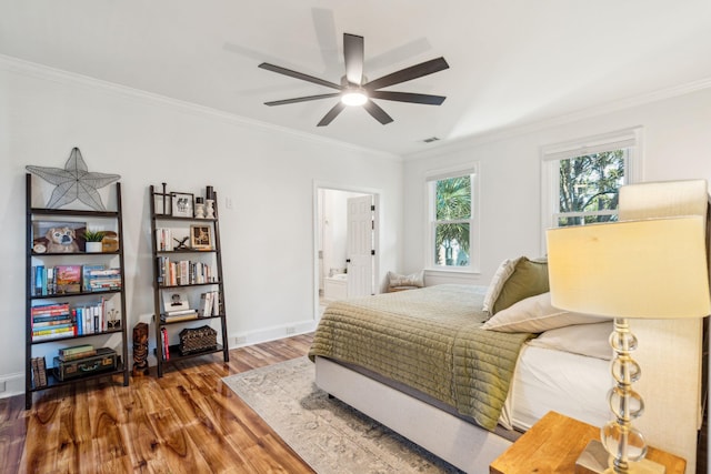 bedroom with hardwood / wood-style floors, ensuite bath, ceiling fan, and ornamental molding