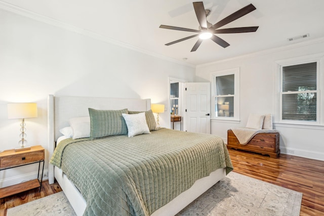 bedroom featuring ceiling fan, crown molding, and hardwood / wood-style flooring