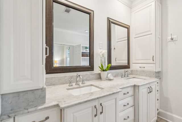 bathroom featuring vanity and ornamental molding