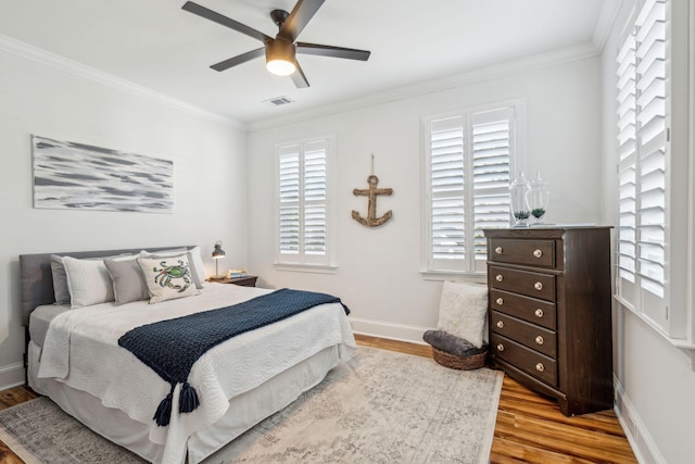 bedroom with ceiling fan, light hardwood / wood-style flooring, and crown molding