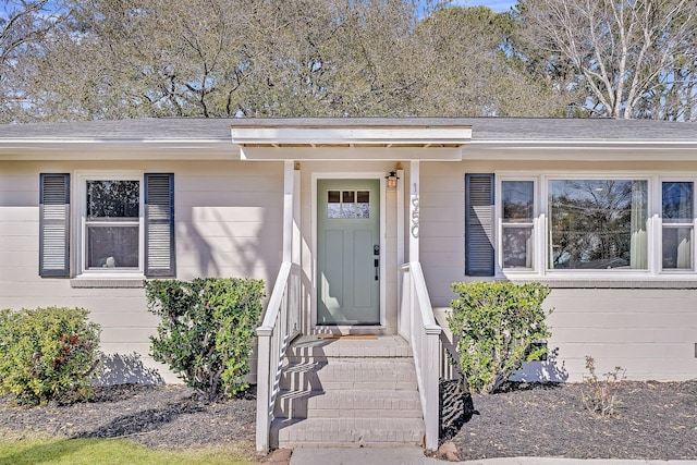 property entrance with roof with shingles