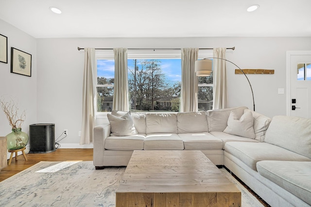 living area featuring wood finished floors, recessed lighting, and a healthy amount of sunlight