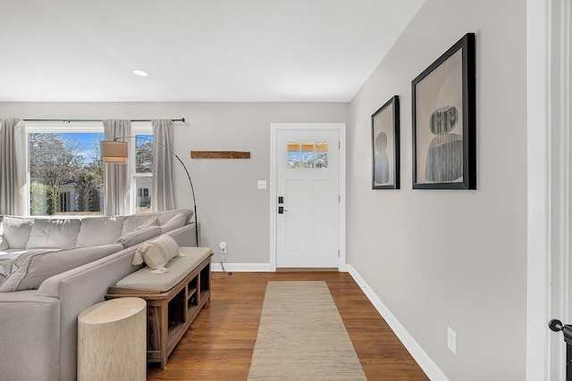 foyer entrance featuring baseboards and dark wood-style flooring