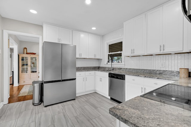 kitchen featuring a sink, white cabinets, and stainless steel appliances