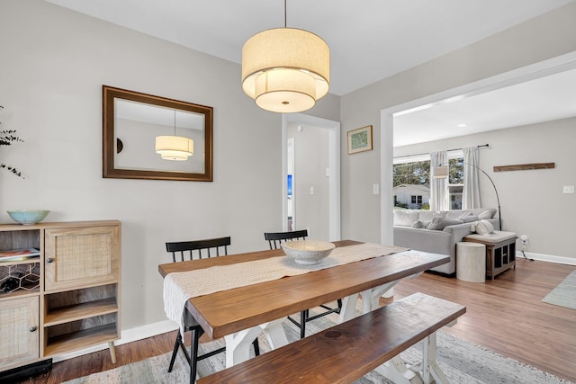 dining space with wood finished floors and baseboards