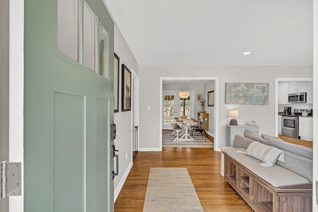 entryway with recessed lighting, wood finished floors, and baseboards