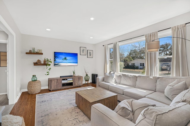 living area with recessed lighting, baseboards, and wood finished floors