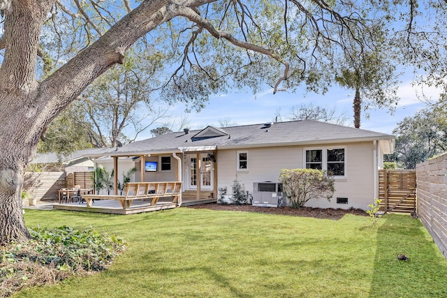 back of house with a lawn, a deck, central AC, a fenced backyard, and crawl space