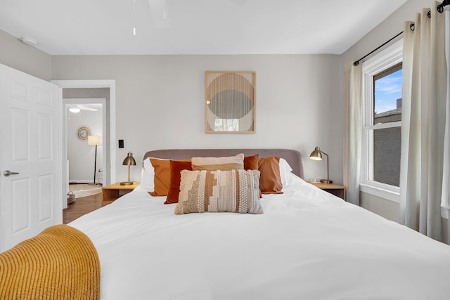 bedroom with dark wood-style flooring