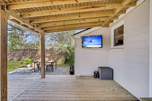 deck featuring outdoor dining area and fence