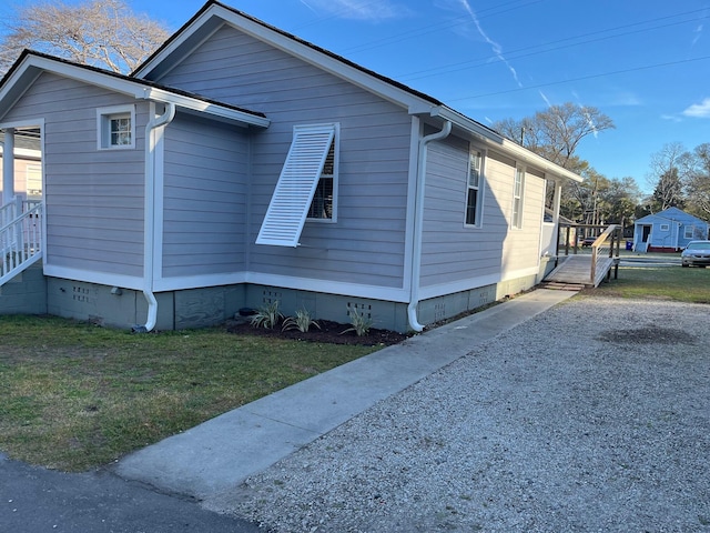 view of home's exterior with crawl space and a lawn