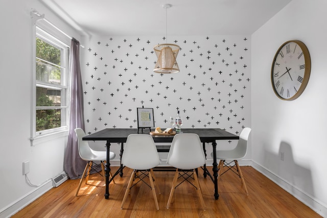 dining space with hardwood / wood-style flooring and a healthy amount of sunlight