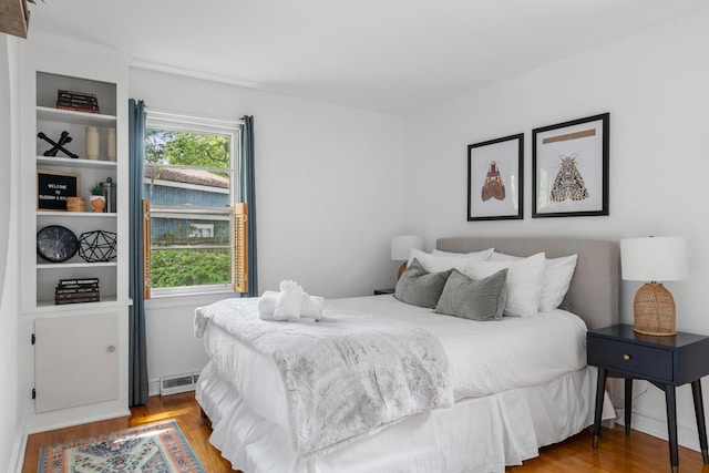 bedroom with hardwood / wood-style flooring