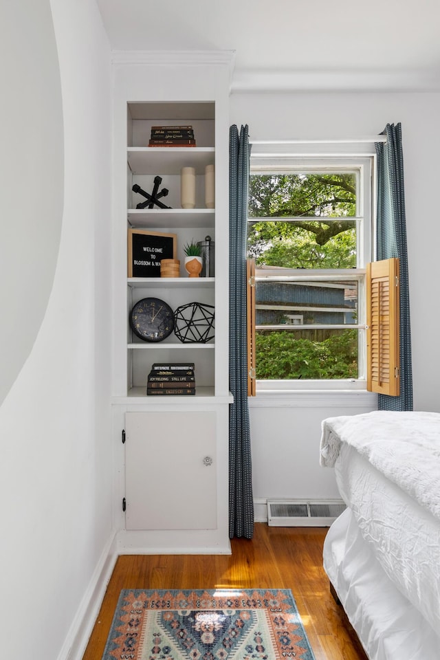 bedroom featuring wood-type flooring and multiple windows