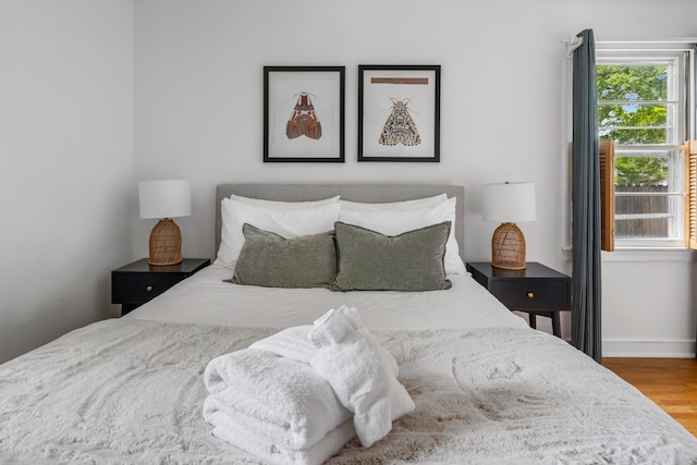 bedroom featuring hardwood / wood-style floors and multiple windows