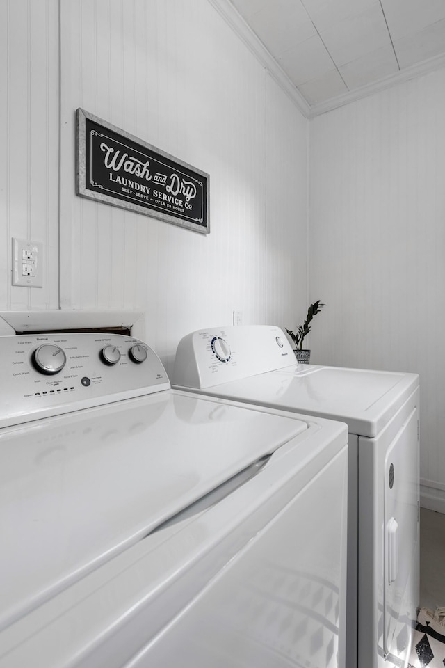 laundry area with independent washer and dryer and ornamental molding