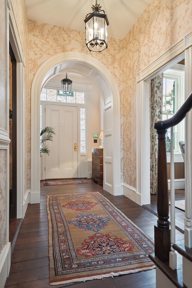 entrance foyer with dark hardwood / wood-style flooring and a chandelier