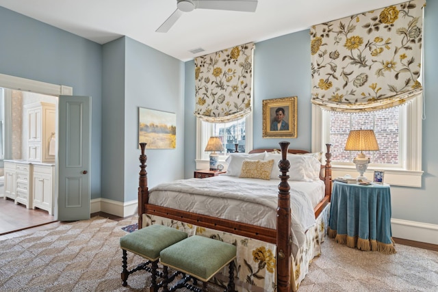 carpeted bedroom with ceiling fan and multiple windows