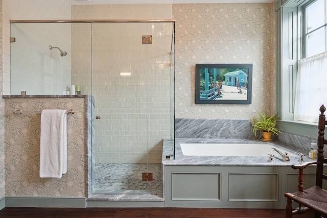 bathroom featuring separate shower and tub