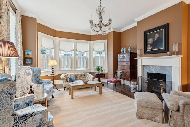 living room featuring crown molding, a fireplace, hardwood / wood-style floors, and a notable chandelier