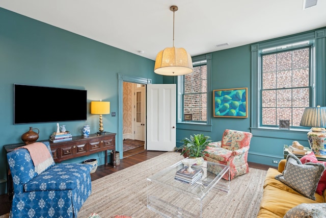 living room featuring a wealth of natural light and dark hardwood / wood-style floors