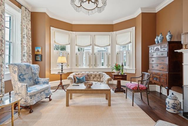 living area featuring an inviting chandelier, ornamental molding, and hardwood / wood-style flooring