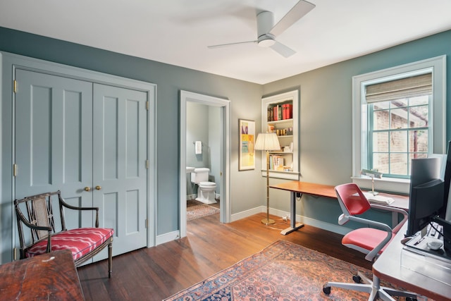 office featuring ceiling fan, hardwood / wood-style flooring, and built in features