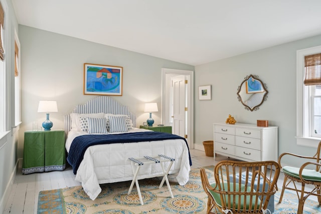 bedroom featuring light hardwood / wood-style floors and vaulted ceiling