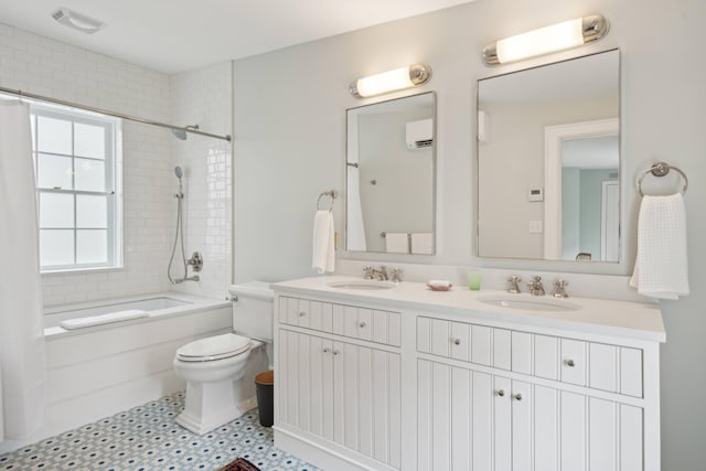 full bathroom featuring washtub / shower combination, toilet, vanity, and a wall mounted air conditioner