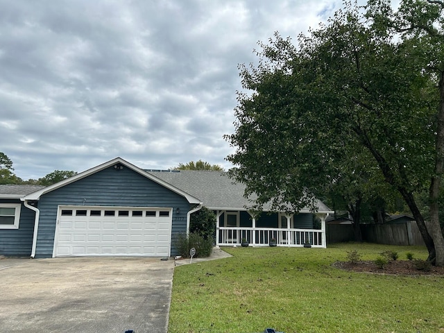 view of front of house featuring a garage, covered porch, and a front yard