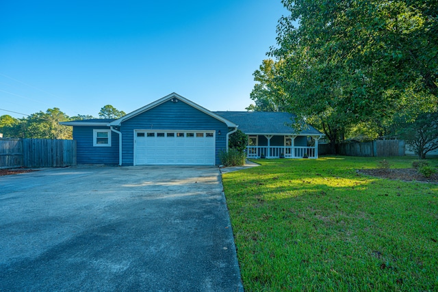 ranch-style house with a garage and a front lawn