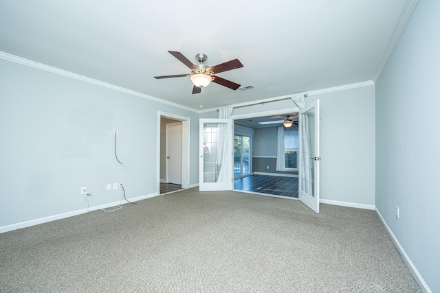 empty room featuring ornamental molding, dark carpet, ceiling fan, and french doors