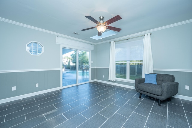 unfurnished room with ceiling fan and crown molding