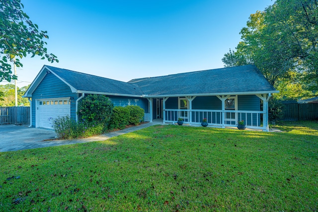 view of front facade featuring covered porch, a front yard, and a garage